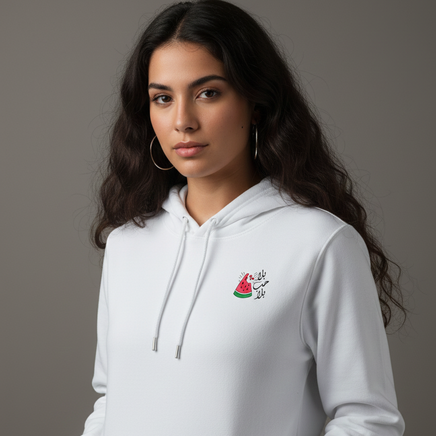 Woman wearing a white hoodie with a small watermelon design on a gray background
