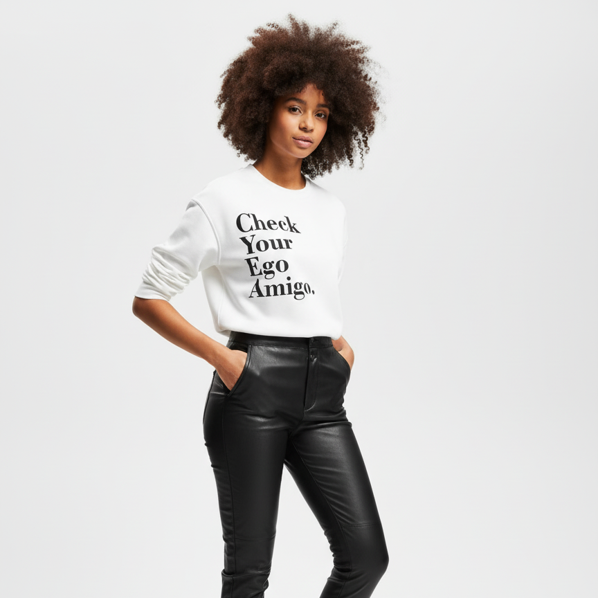 Person wearing a white sweatshirt with text and black pants on a light gray background