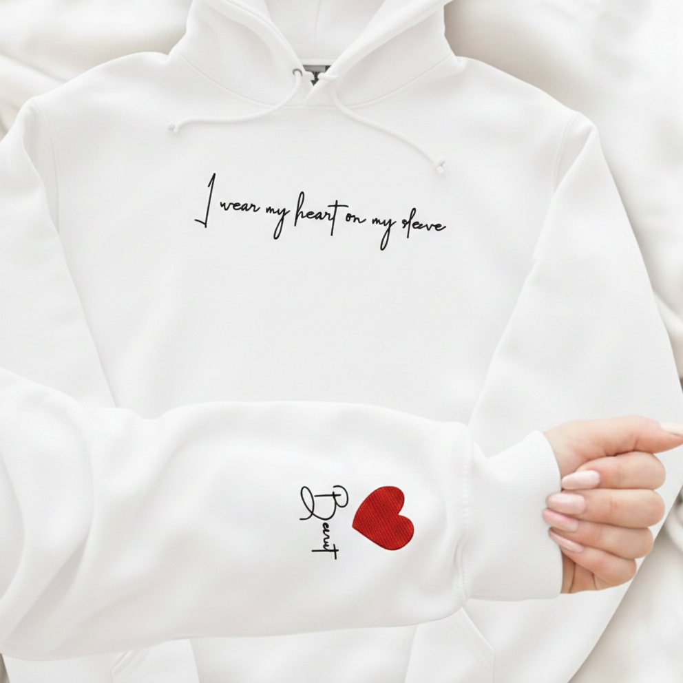 White hoodie with embroidered heart  design on the sleeve