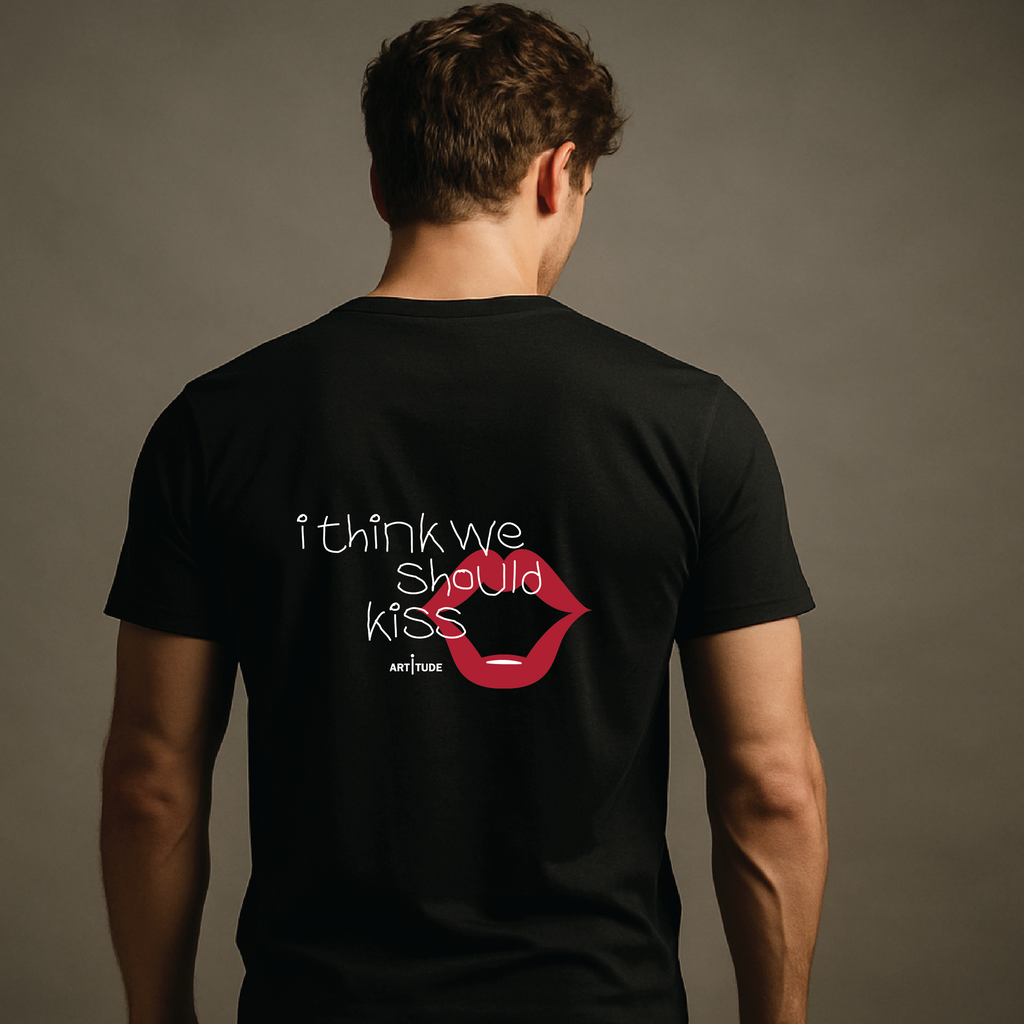 Person wearing a black t-shirt with a graphic and text on the back against a gray background