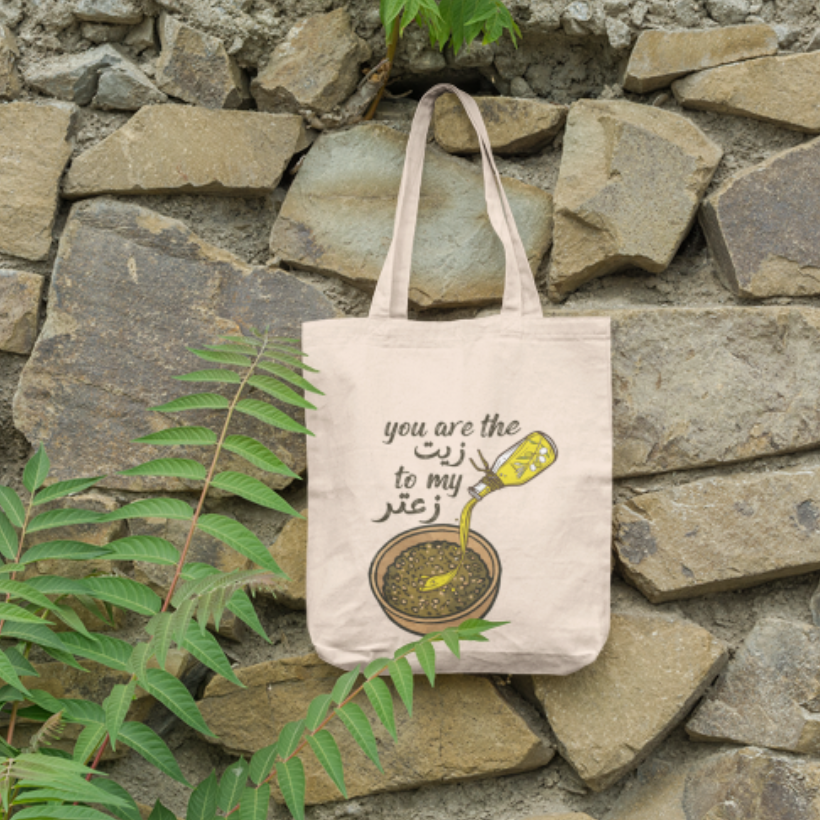 Tote bag with a design and text on a stone wall background